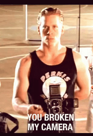 A Man Holding A Camera With The Words You Broken My Camera Written On The Bottom GIF
