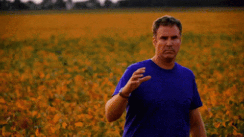 A Man Holding A Can Of Old Milwaukee Beer In A Field GIF