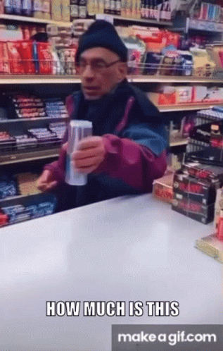A Man Holding A Can Of Soda In A Store With The Words How Much Is This Make A Gif.com Below Him GIF