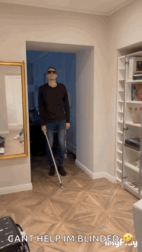 A Man Holding A Cane In A Hallway With The Words Cant Help Im Blinded GIF