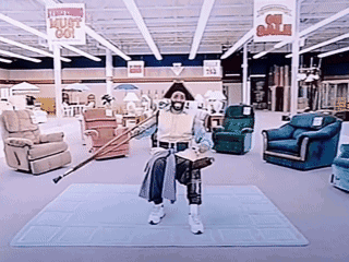 A Man Holding A Cane In A Store With A Sign That Says " Must Go " GIF