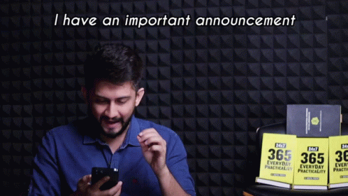 A Man Holding A Cell Phone With The Words I Have An Important Announcement Behind Him GIF