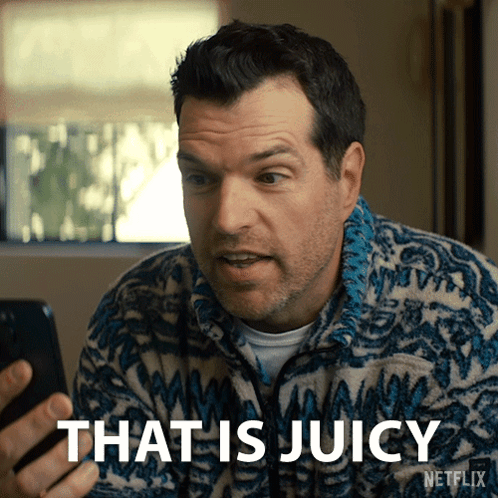 A Man Holding A Cell Phone With The Words That Is Juicy Written On The Bottom GIF