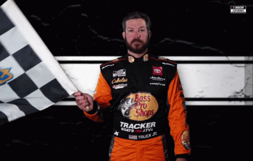 A Man Holding A Checkered Flag Wears A Bass Pro Shops Uniform GIF