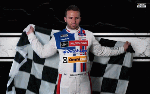 A Man Holding A Checkered Flag With The Word Motorcraft On His Shirt GIF