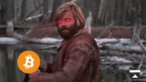 a man holding a coin with a b on it