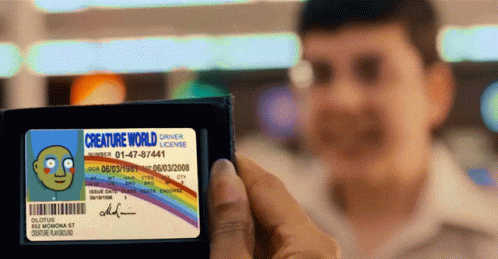 A Man Holding A Creature World Driver 'S License GIF