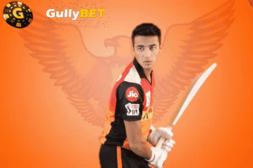 A Man Holding A Cricket Bat In Front Of A Gully Bet Logo GIF