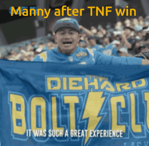 A Man Holding A Diehard Bolts Club Banner In Front Of A Crowd GIF