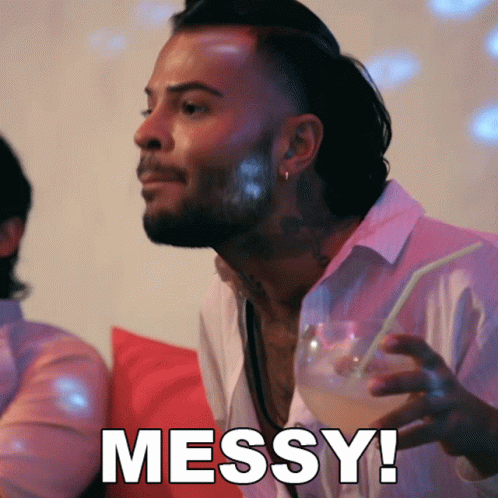 A Man Holding A Drink With The Word Messy Written On The Bottom GIF