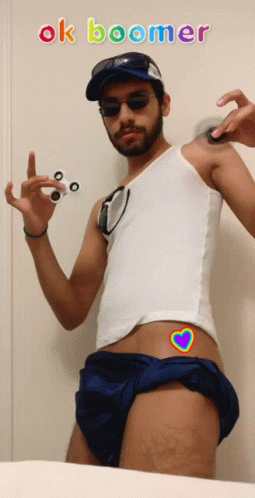 A Man Holding A Fidget Spinner With The Words Ok Boomer Written Above Him GIF