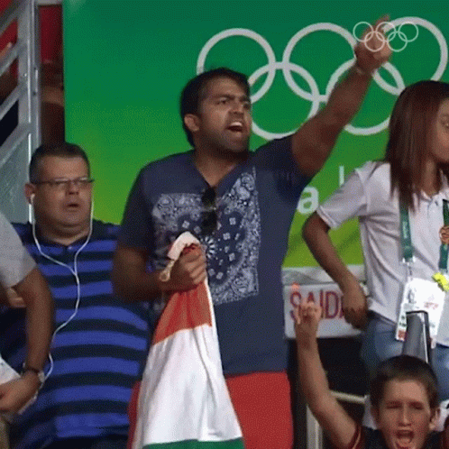 Man Holding Flag In Front Of Said Sign GIF