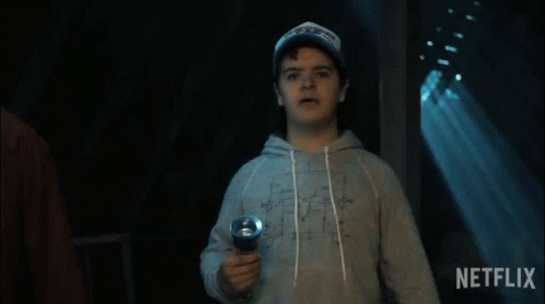 A Man Holding A Flashlight With A Netflix Logo In The Background GIF