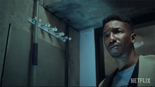 A Man Holding A Flashlight With A Netflix Logo In The Background GIF