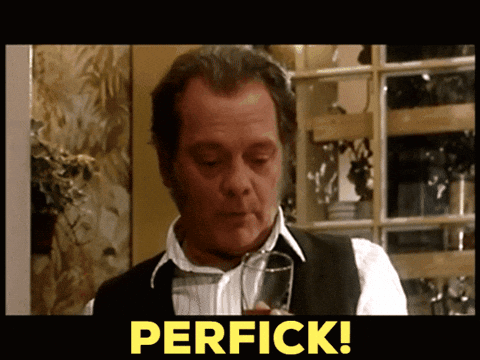 A Man Holding A Glass With The Word Perfick On The Bottom GIF