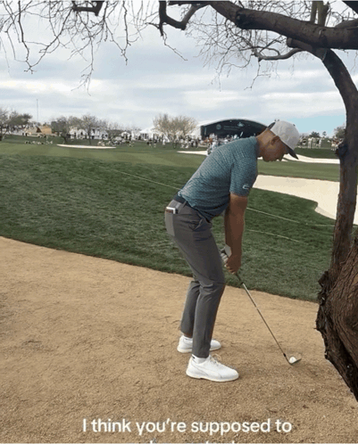 A Man Holding A Golf Club On A Golf Course With The Words I Think You 'Re Supposed To GIF