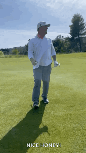 A Man Holding A Golf Club On A Golf Course With The Words Nice Honey Above Him GIF