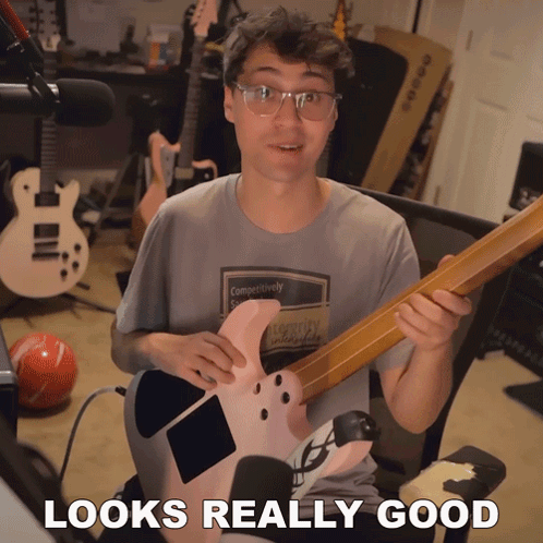 Man Holding Guitar Looks Really Good GIF