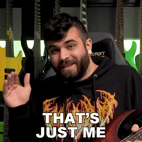 A Man Holding A Guitar With The Words That 'S Just Me On His Shirt GIF