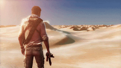 A Man Holding A Gun Walking Through A Desert Landscape GIF