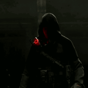 A Man Holding A Gun With A Red Circle On His Wrist GIF