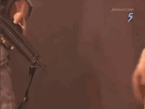 Man Holding Gun With Number 5 GIF