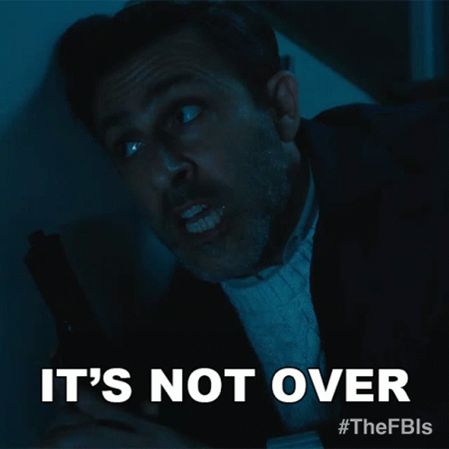 A Man Holding A Gun With The Words It 'S Not Over Above Him GIF