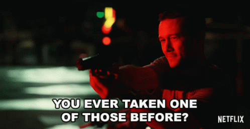 A Man Holding A Gun With The Words " You Ever Taken One Of Those Before " On The Bottom GIF