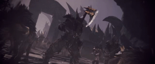 A Man Holding A Large Sword In A Dark Room GIF