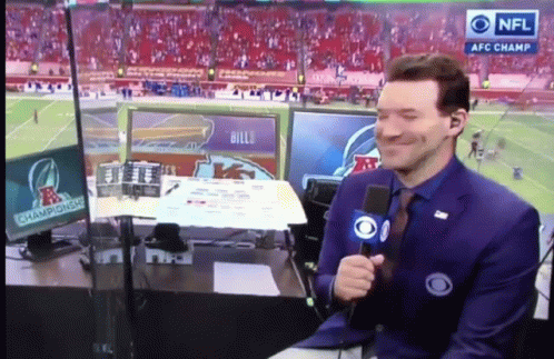 A Man Holding A Microphone In Front Of A Screen That Says Nfl Afc Champions GIF
