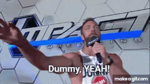 A Man Holding A Microphone In Front Of A Sign That Says Impact Wrestling GIF
