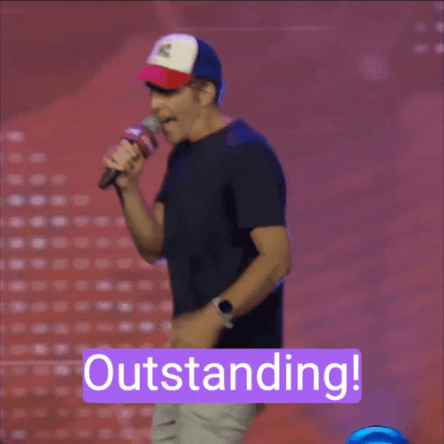 A Man Holding A Microphone With The Word Outstanding On The Bottom GIF