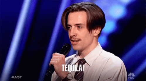 A Man Holding A Microphone With The Word Tequila Written On It GIF