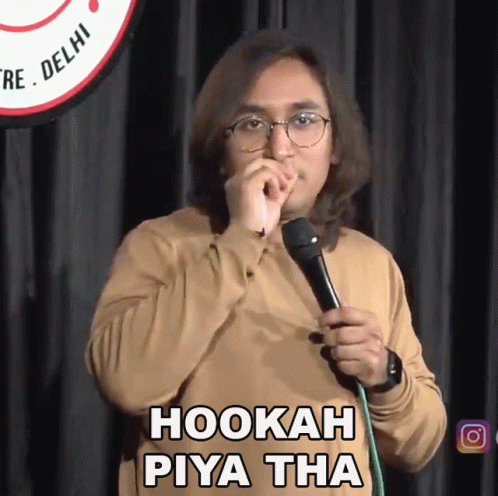 A Man Holding A Microphone With The Words Hookah Piya Tha Written On It GIF