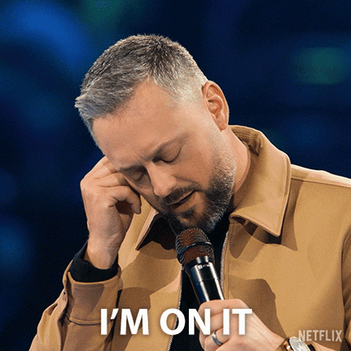 A Man Holding A Microphone With The Words " I 'M On It " Below Him GIF