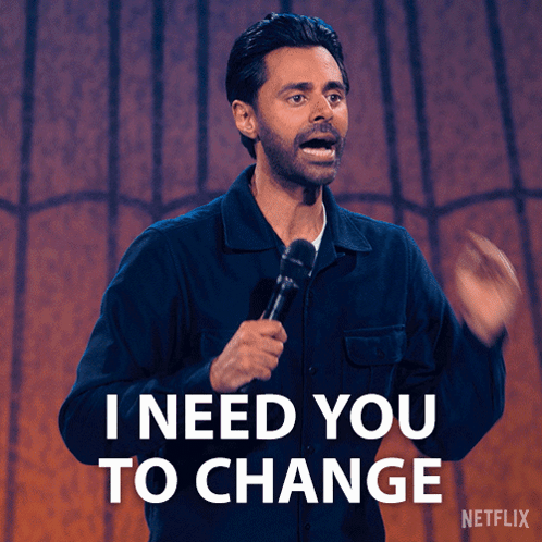 A Man Holding A Microphone With The Words I Need You To Change Behind Him GIF