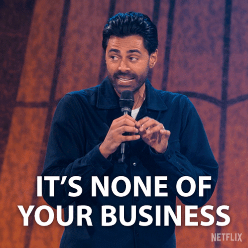 A Man Holding A Microphone With The Words It 'S None Of Your Business GIF