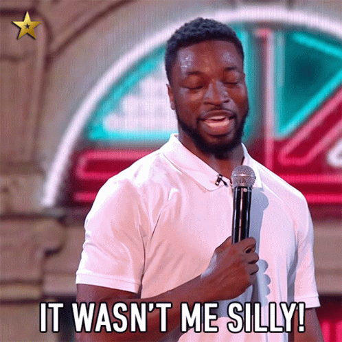 A Man Holding A Microphone With The Words It Wasn 'T Me Silly GIF