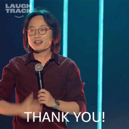 A Man Holding A Microphone With The Words Thank You Below Him GIF