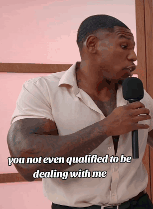 A Man Holding A Microphone With The Words " You Not Even Qualified To Be Dealing With Me " On The Bottom GIF