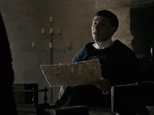 A Man Holding A Piece Of Paper That Says " Paper Says " GIF