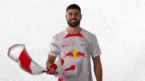 a man holding a red and white flag with a bull on it
