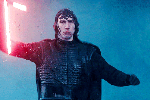 A Man Holding A Red Light Saber In His Hand GIF