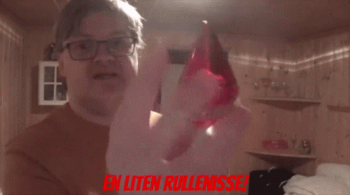 A Man Holding A Red Object With The Words En Uten Rullenisse In Red GIF