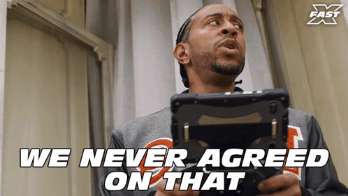 A Man Holding A Remote Control With The Words " We Never Agreed On That " Above Him GIF