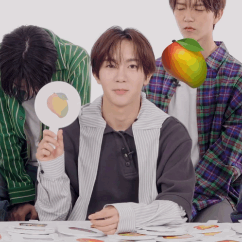 A Man Holding A Sign That Says Peach On It GIF