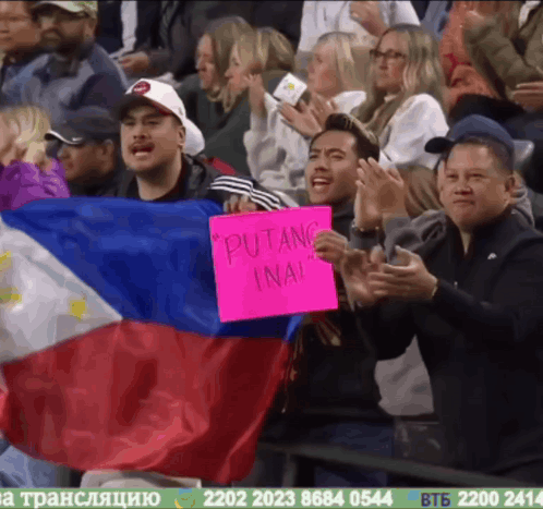 A Man Holding A Sign That Says " Putang Ina " GIF