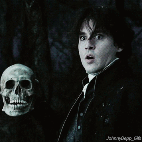 A Man Holding A Skull With A Surprised Look On His Face And The Words Johnnydepp_gifs Below Him GIF