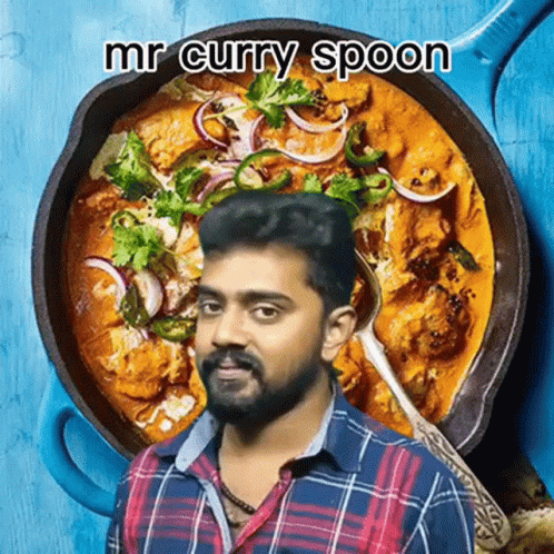 A Man Holding A Spoon In Front Of A Pan Of Curry GIF