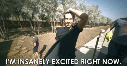 A Man Holding A Surfboard With The Words I 'M Insanely Excited Right Now GIF